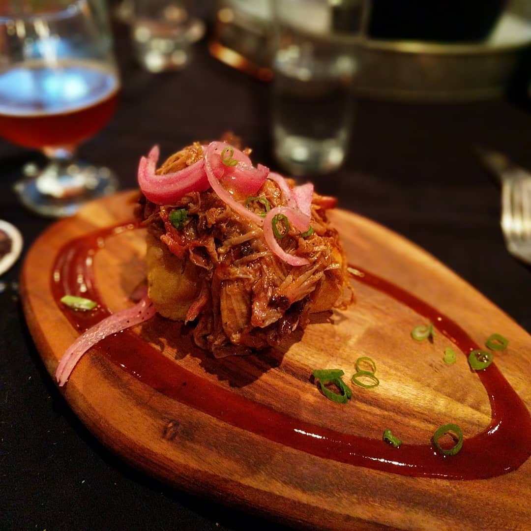 #4204mainstreetbrewing #craftedstl house smoked pulled pork with pickled red onions and served on a corn cake base. #stlouis #citylife