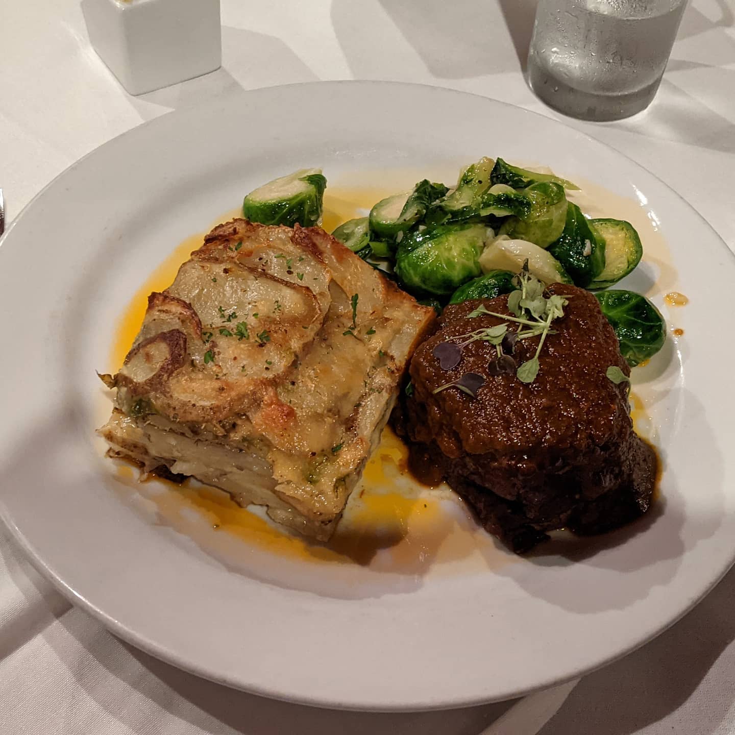 #okc #foodporn. Delicious beef short rib, sauteed brussels sprouts and au gratin potatoes. Nice with a good lager.