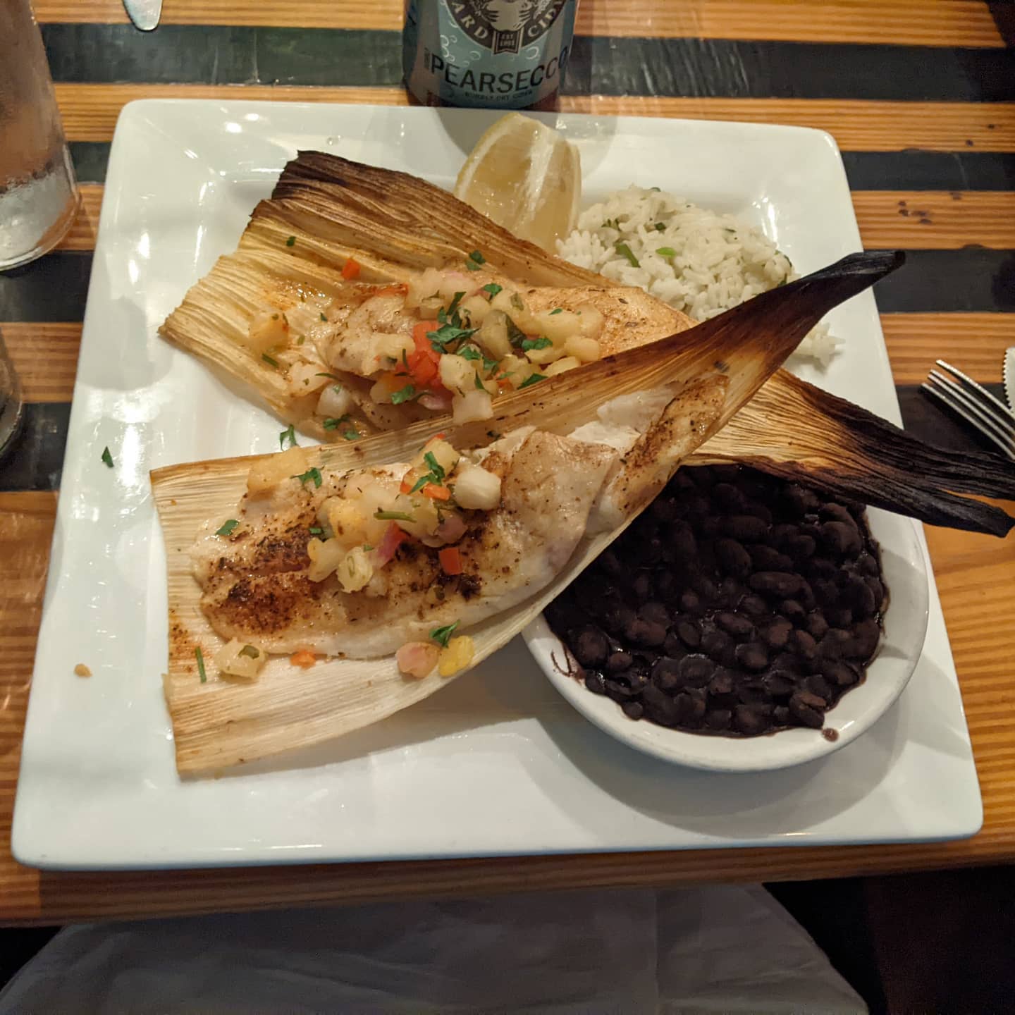 I couldn't resist returning here for more great seafood. This is hogfish blackened in corn husks. Sides are cilantro lime rice and black beans. #foodporn
