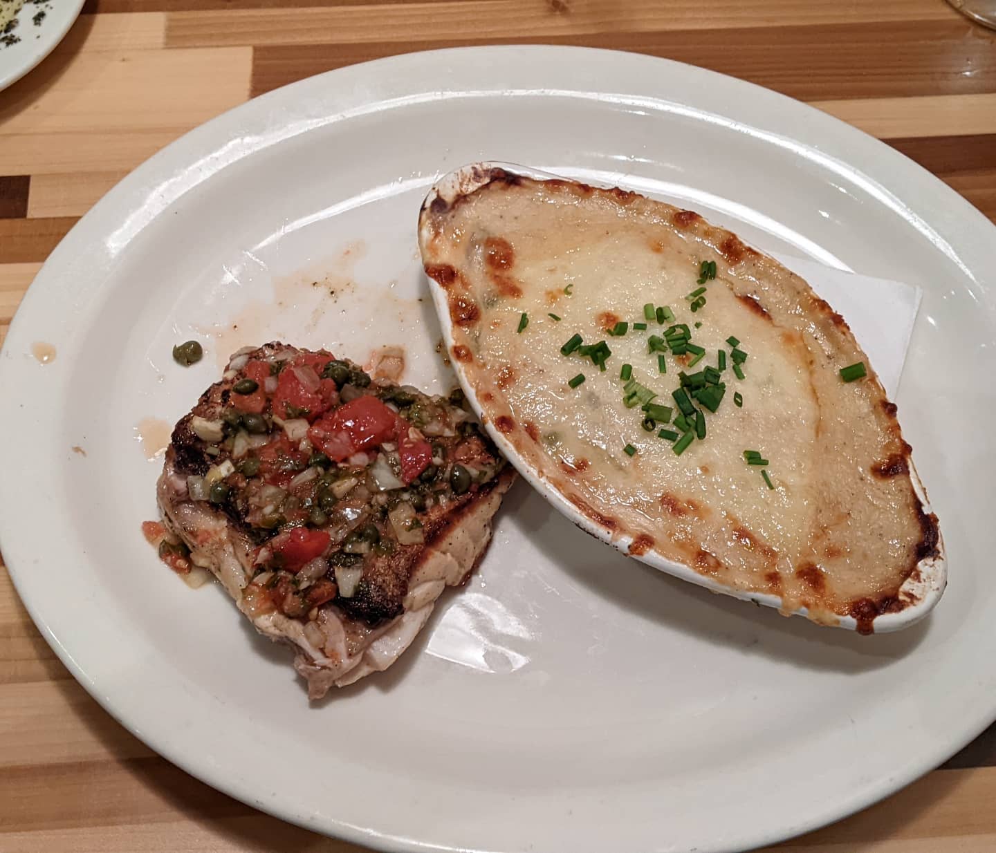 Continuing my seafood #foodporn theme... Red snapper with tomato, lemon and capers, with a side of au gratin potatoes. I am going to miss this fresh fish when I get home.
